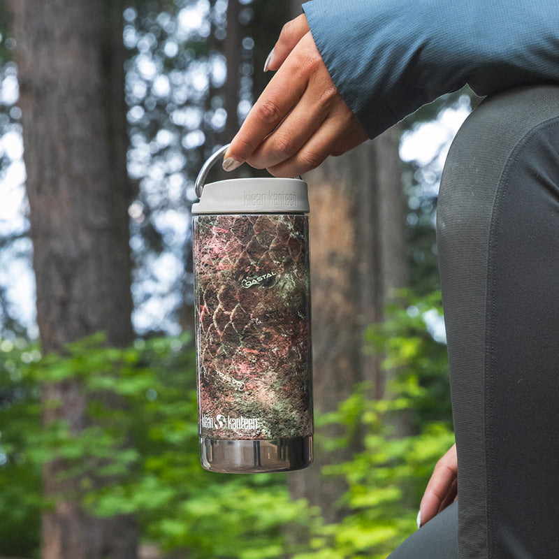 12oz-tkwide-with-cafe-cap-mossy-oak-h6 12oz_tumbler_mossyoak_rainbowtrout_hand_closeup_square.jpg